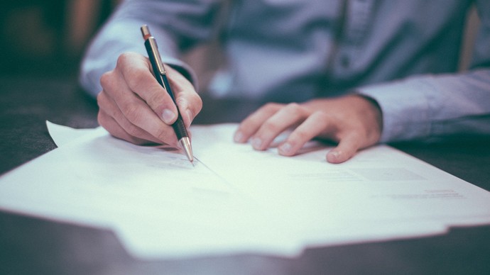 Eine Hand hält einen Stift und schreibt